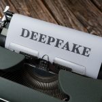 Close-up of a typewriter with the word Deepfake typed on paper, illustrating AI content detection concerns