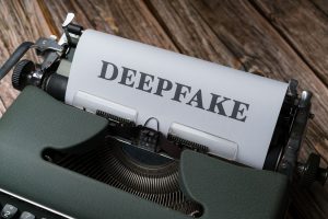 Close-up of a typewriter with the word Deepfake typed on paper, illustrating AI content detection concerns